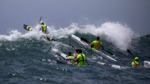 MWKC Alumni Tim Jacobs leading through large waves at Barrenjoey Heads in the 20 Beaches race
